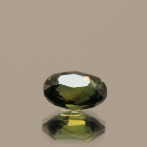 Green sapphire gemstone 1.25 carat oval cut, untreated, Madagascar origin, dimensions 7.31 × 5.18 × 3.83 mm, GFCO certified.