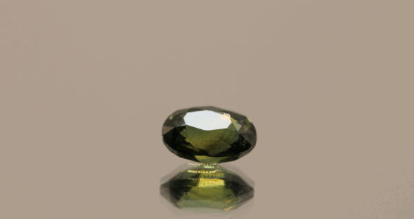 Green sapphire gemstone 1.25 carat oval cut, untreated, Madagascar origin, dimensions 7.31 × 5.18 × 3.83 mm, GFCO certified.