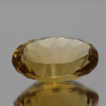 Natural oval cut citrine gemstone with yellow-orange color, 20.30 × 12.80 mm