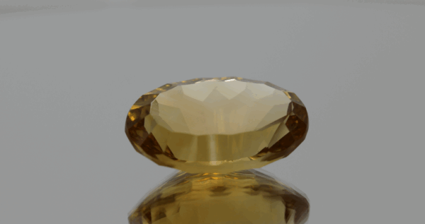 Natural oval cut citrine gemstone with yellow-orange color, 20.30 × 12.80 mm