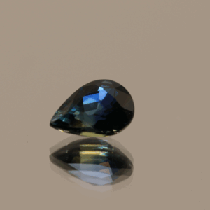 Royal blue pear-shaped sapphire, 0.94 carat, 7.01 × 5.04 × 3.56 mm, heat-treated, Madagascar origin, IGS certified.