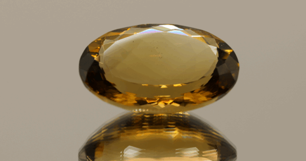 Brownish yellow oval-shaped smoky quartz, 23.97 carat, 24.4 × 16.8 × 10.0 mm, no treatment, unknown origin.