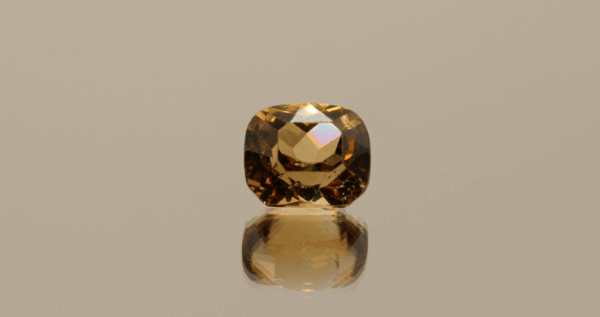Light brown cushion-shaped topaz, 4.73 carat, 9.6 × 8.3 × 6.6 mm, no treatment, unknown origin.