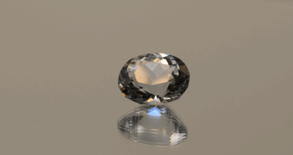 Natural oval cut aquamarine gemstone with colorless hue, 11.4 × 10.2 mm