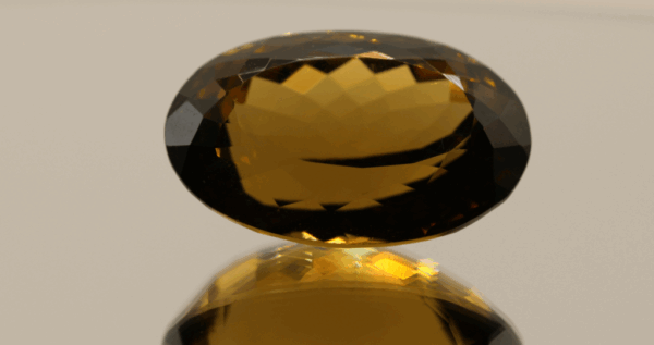 Brownish yellow oval-shaped smoky quartz, 37.8 carat, 26.2 × 17.1 × 14.1 mm, no treatment, unknown origin.