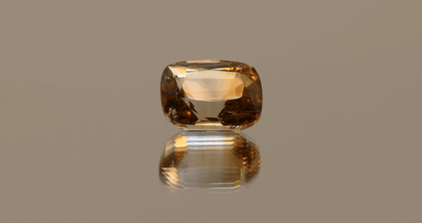 Light brown cushion-shaped topaz, 5.64 carat, 11.33 × 8.79 × 6.56 mm, no treatment, unknown origin.