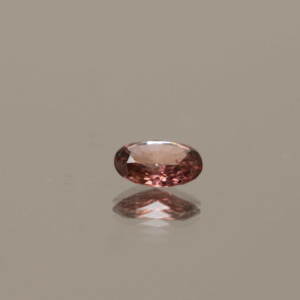 Natural Padparadscha Oval sapphire gemstone, 0.54 carat, oval cut, orange pink color, unheated, loose gemstone, dimensions 5.84 × 5.03 × 2.09 mm, origin Madagascar, AIG certified.