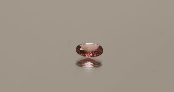 Natural Padparadscha Oval sapphire gemstone, 0.54 carat, oval cut, orange pink color, unheated, loose gemstone, dimensions 5.84 × 5.03 × 2.09 mm, origin Madagascar, AIG certified.