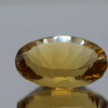 Natural oval cut citrine gemstone with yellow-orange color, 21.00 × 14.10 mm