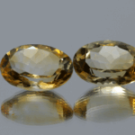 Natural oval cut citrine gemstone with yellow-orange color, 14.22 × 10.17 mm