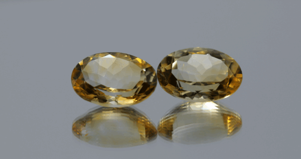 Natural oval cut citrine gemstone with yellow-orange color, 14.22 × 10.17 mm