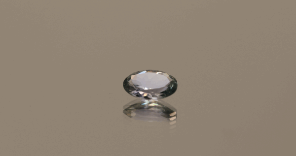 Violet green oval-shaped tanzanite, 0.58 carat, 6.95 × 4.9 × 2.52 mm, no treatment, unknown origin, GIA certified.