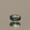 Greenish blue sapphire gemstone, 1 carat, oval cut, heat-treated, loose gemstone, dimensions 6.48 × 5.1 × 2.94 mm, origin Madagascar, GFCO certified.