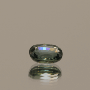 Greenish blue sapphire gemstone, 1 carat, oval cut, heat-treated, loose gemstone, dimensions 6.48 × 5.1 × 2.94 mm, origin Madagascar, GFCO certified.