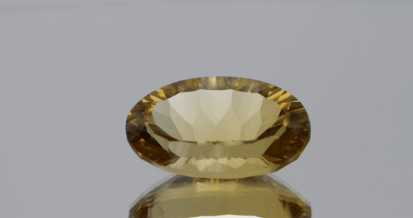 Natural oval cut citrine gemstone with yellow-orange color, 20.70 × 12.50 mm
