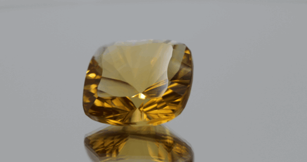 Natural cushion cut citrine gemstone with yellow-orange color, 16.9 × 16.9 mm