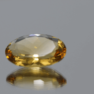 Natural oval cut citrine gemstone with yellow-orange color, 16.90 × 12.70 mm