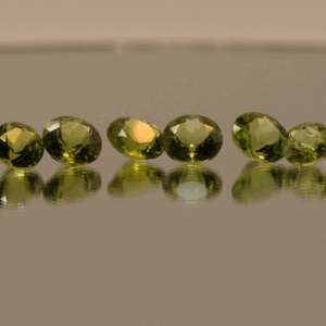 Set of 16 natural peridot gemstones, round cut, yellowish green color, untreated, total weight 13.73 carat, dimensions 6.8 × 5.1 × 3–3.9 mm, ideal for fine jewelry.