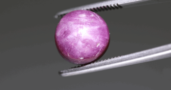 Natural star ruby gemstone, 9.28 carat, cabochon cut, red-purple color, unheated, loose gemstone, dimensions 10.36 × 10.3 × 7.09 mm, origin unknown, GFCO certified.