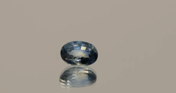 Blue sapphire gemstone 1.01 carat oval cut, heat-treated, Madagascar origin, dimensions 6.98 × 5.07 × 3.26 mm, GFCO certified.