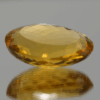 Natural oval cut citrine gemstone with yellow-orange color, 23.10 × 16.30 mm