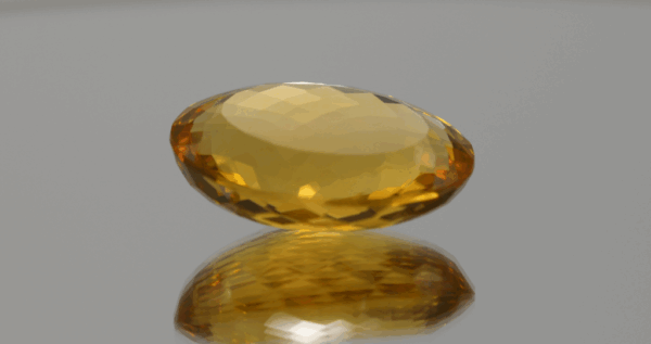 Natural oval cut citrine gemstone with yellow-orange color, 23.10 × 16.30 mm