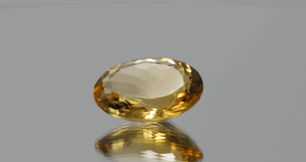 Natural oval cut citrine gemstone with yellow-orange color, 17.10 × 13.30 mm