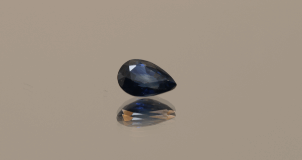 Royal blue pear-shaped sapphire, 0.8 carat, 6.79 × 4.97 × 2.98 mm, heat-treated, Madagascar origin, IGS certified.