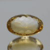 Natural oval cut citrine gemstone with yellow-orange color, 18.30 × 12.80 mm