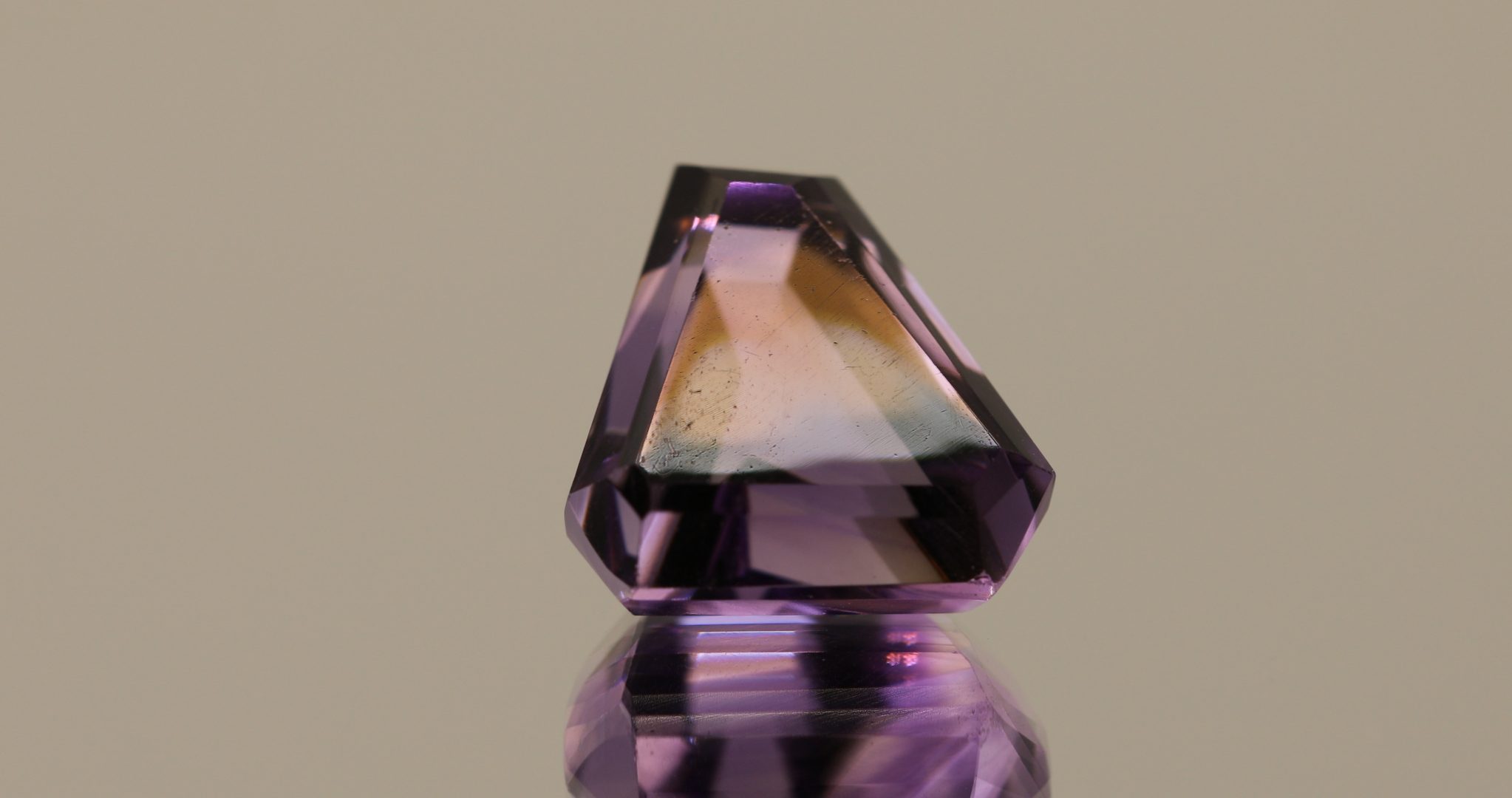 Natural trapezoid cut amethyst gemstone with purple violet color, 12.20 × 11.10 mm