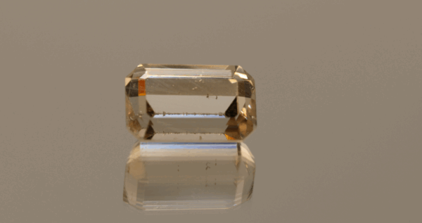 Light brown octagon-shaped topaz, 10.91 carat, 14.2 × 8.8 × 7.6 mm, no treatment, unknown origin.