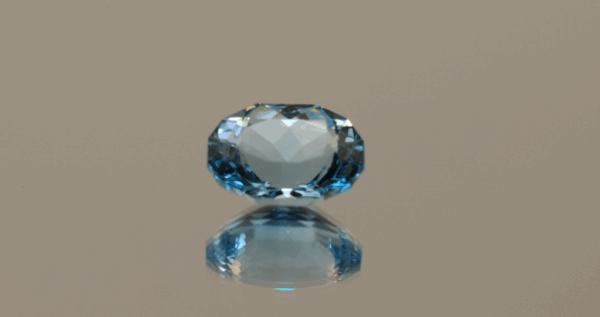 Blue oval-shaped topaz, 5.75 carat, 12.32 × 9.43 × 6.49 mm, no treatment, unknown origin.
