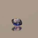 Natural sapphire gemstone, 0.65 carat, cushion cut, blue to purple color, unheated, loose gemstone, color change effect, dimensions 5.15 × 5.12 × 2.68 mm, origin Madagascar, AIG certified.