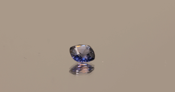 Natural sapphire gemstone, 0.65 carat, cushion cut, blue to purple color, unheated, loose gemstone, color change effect, dimensions 5.15 × 5.12 × 2.68 mm, origin Madagascar, AIG certified.