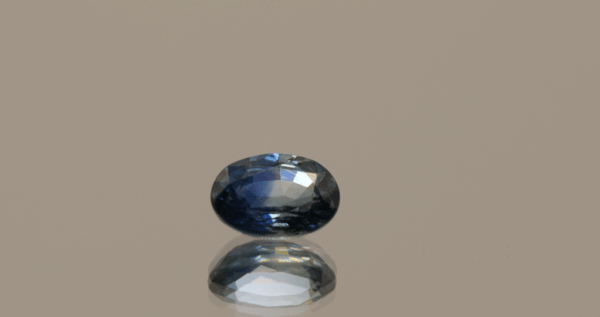 Blue sapphire gemstone 1.06 carat oval cut, heat treated, Madagascar origin, dimensions 6.99 × 5.08 × 3.29 mm, GFCO certified.