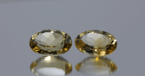 Natural oval cut citrine gemstone with yellow-orange color, 14.15 × 10.00 mm
