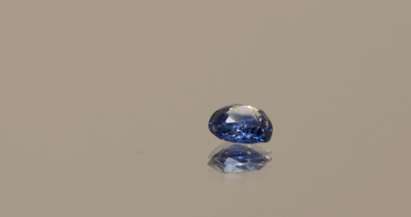 Blue pear-shaped sapphire, 0.57 carat, 5.48 × 5.33 × 2.37 mm, heat-treated, unknown origin, AIG certified.