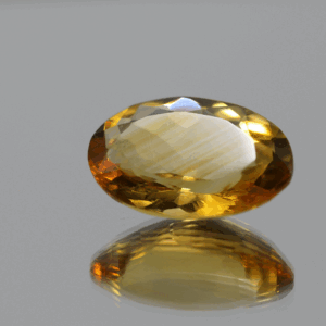 Natural oval cut citrine gemstone with yellow-orange color, 16.80 × 12.10 mm