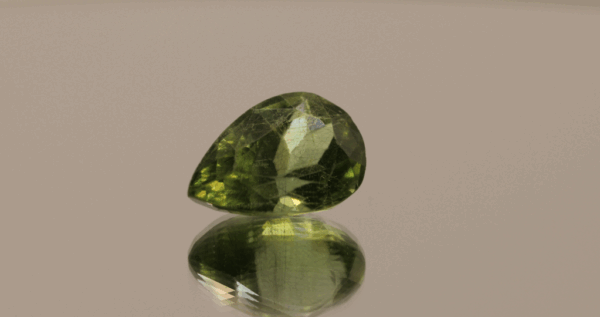 Natural 7.82 carat peridot, pear cut, yellowish green color, untreated, loose gemstone, dimensions 15.11 × 10.23 × 8.22 mm, perfect for fine jewelry.