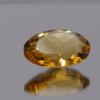 Natural oval cut citrine gemstone with yellow-orange color, 17.60 × 13.00 mm