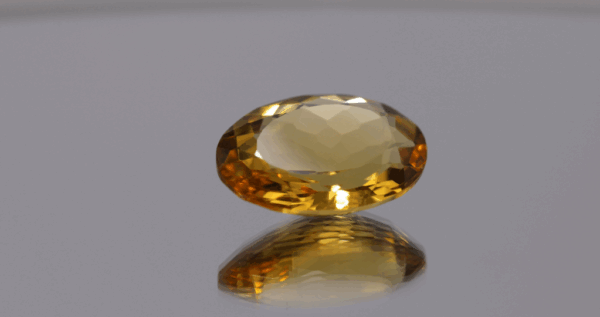 Natural oval cut citrine gemstone with yellow-orange color, 17.60 × 13.00 mm