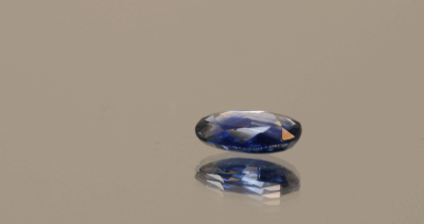 Blue sapphire crystal gemstone 1.42 carat oval cut, heat-treated, Madagascar origin, dimensions 8.66 × 5.43 × 2.85 mm, AIG certified.