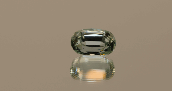 Light green cushion-shaped spodumene, 5.92 carat, 12.3 × 7.8 × 7.3 mm, no treatment, unknown origin.