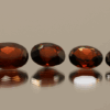 Set of 4 natural spessartite garnets, 7.09 carats total, oval cut, orange-red color, untreated