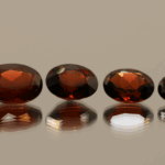 Set of 4 natural spessartite garnets, 7.09 carats total, oval cut, orange-red color, untreated
