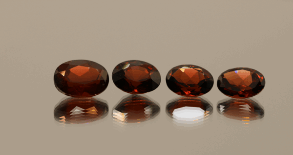 Set of 4 natural spessartite garnets, 7.09 carats total, oval cut, orange-red color, untreated
