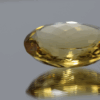 Natural oval cut citrine gemstone with yellow-orange color, 23.50 × 18.90 mm