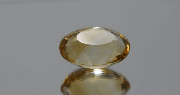 Natural oval cut citrine gemstone with yellow-orange color, 18.60 × 13.50 mm