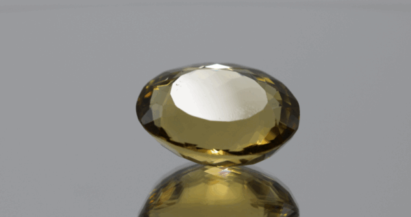 Natural oval cut citrine gemstone with yellow-orange color, 18.80 × 14.80 mm