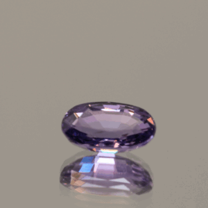 Violet to reddish purple oval-shaped sapphire color change, 1.22 carat, 7.79 × 4.70 × 3.22 mm, no treatment, Madagascar origin, AIG certified.